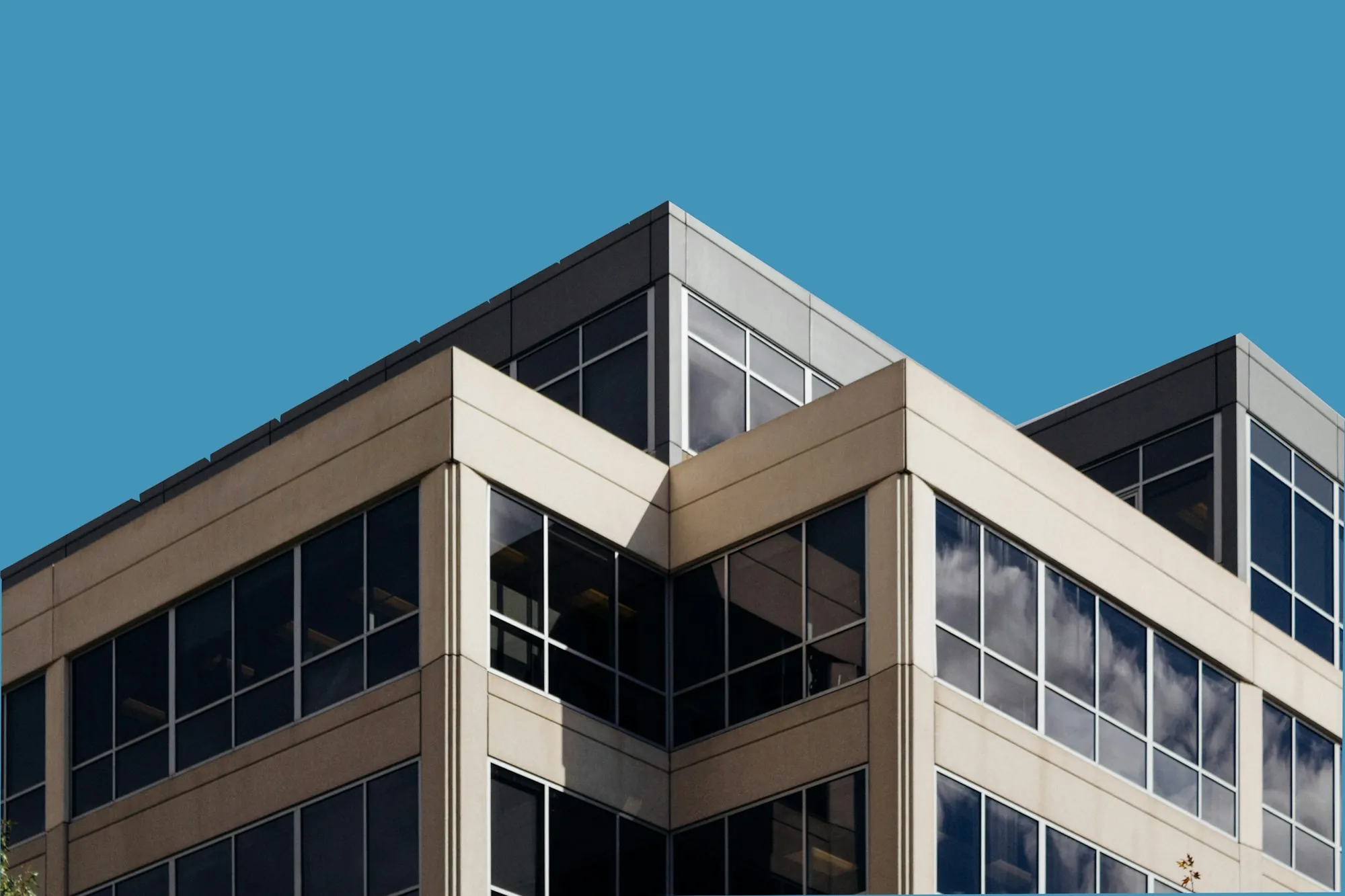 Mid-rise office building with tan panels and dark windows, the kind of commercial property buyers inspect during due diligence in Delano